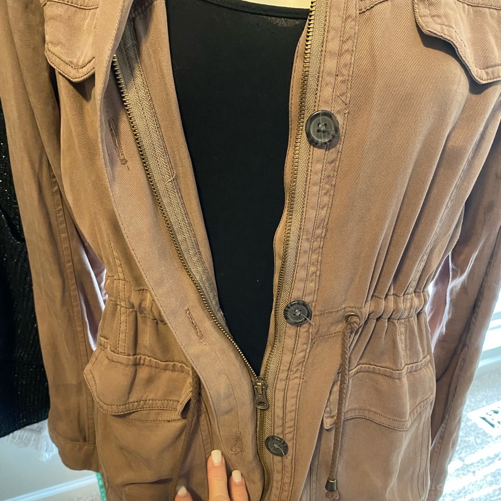 Cute jacket. Dark tan in color.